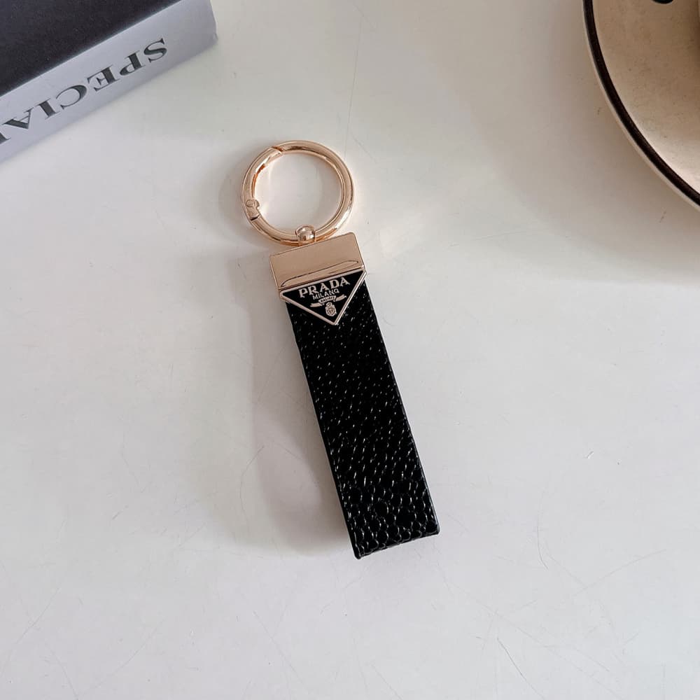 Prada Pebble Grain Leather Luxury Keychain - Signature Triangle Logo with Gold-Tone Hardware