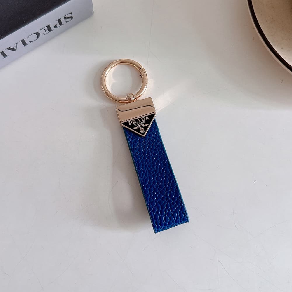 Prada Pebble Grain Leather Luxury Keychain - Signature Triangle Logo with Gold-Tone Hardware