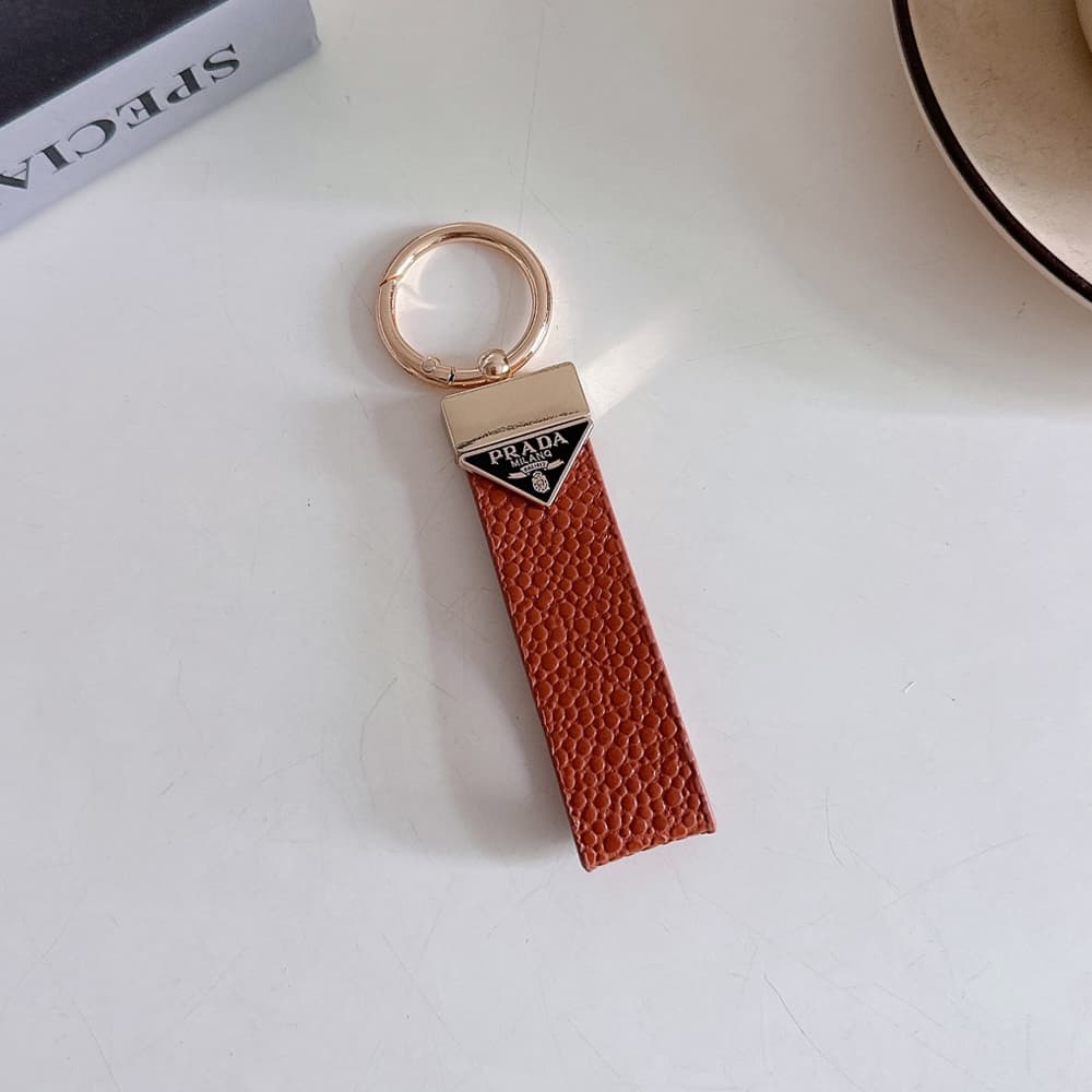 Prada Pebble Grain Leather Luxury Keychain - Signature Triangle Logo with Gold-Tone Hardware