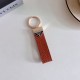 Prada Pebble Grain Leather Luxury Keychain - Signature Triangle Logo with Gold-Tone Hardware