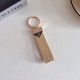Prada Pebble Grain Leather Luxury Keychain - Signature Triangle Logo with Gold-Tone Hardware