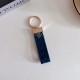 Prada Woven Leather Luxury Keychain - Signature Triangle Logo with Gold-Tone Hardware