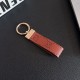 Gucci Embossed GG Monogram Leather Luxury Keychain - Gold-Tone Metal Accents