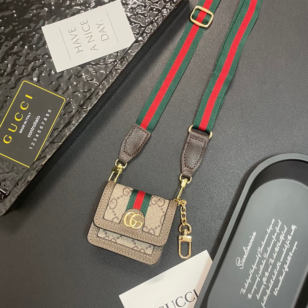 Gucci GG Luxury AirPods & Samsung Buds Case - Monogram with Web Strap & Metal Logo Gucci GG Luxury AirPods & Samsung Buds Case - Monogram with Web Strap & Metal Logo