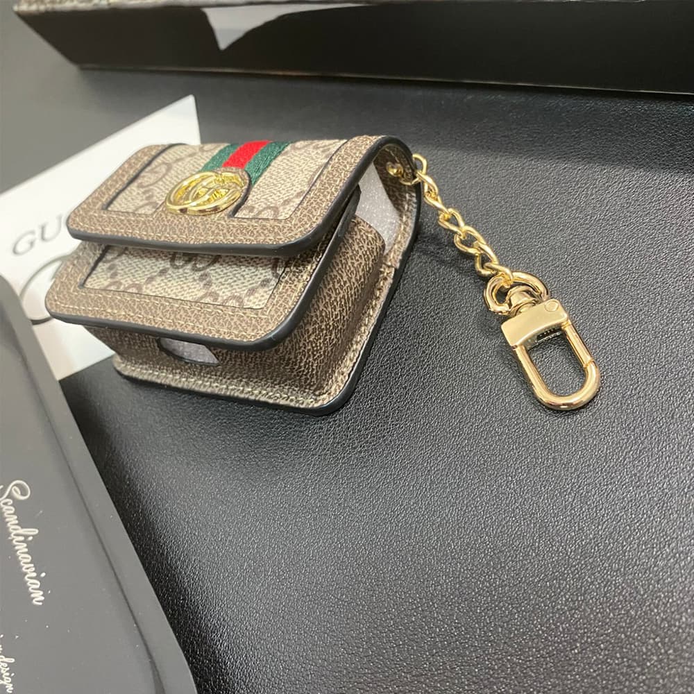 Gucci GG Luxury AirPods & Samsung Buds Case - Monogram with Web Strap & Metal Logo Gucci GG Luxury AirPods & Samsung Buds Case - Monogram with Web Strap & Metal Logo