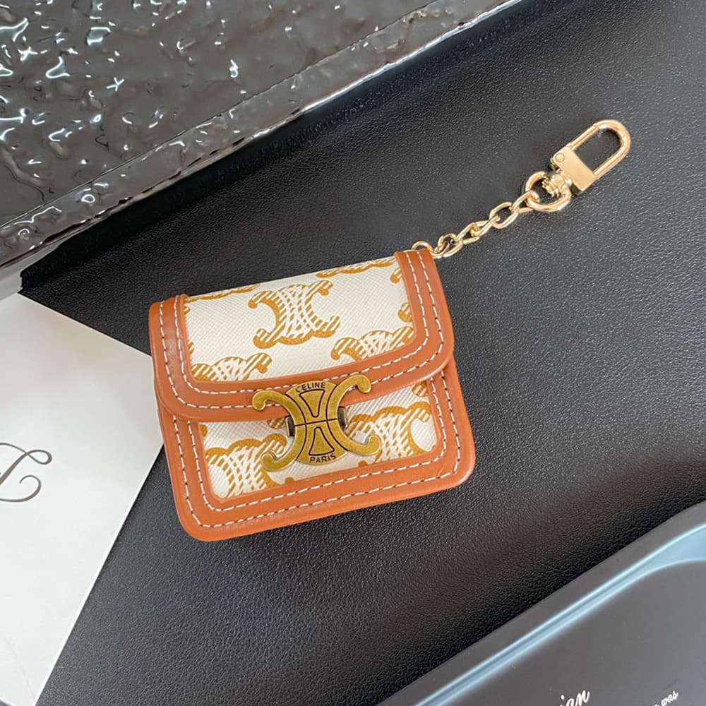 CELINE Triomphe Luxury AirPods & Samsung Buds Case - Embroidered Monogram with Gold Charm CELINE Triomphe Luxury AirPods & Samsung Buds Case - Embroidered Monogram with Gold Charm