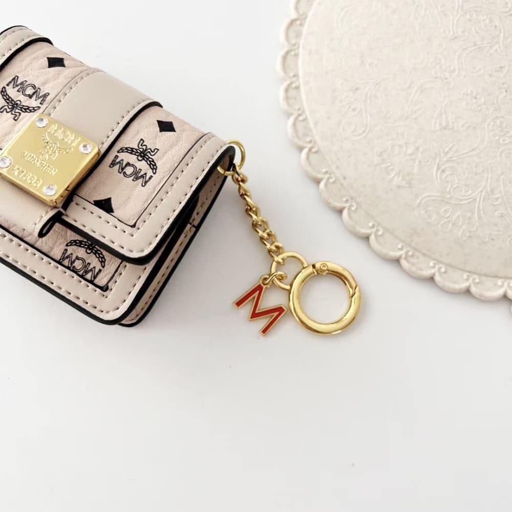 MCM Luxury AirPods & Samsung Buds Case - Monogram Leather with Detachable 'M' Chain MCM Luxury AirPods & Samsung Buds Case - Monogram Leather with Detachable 'M' Chain