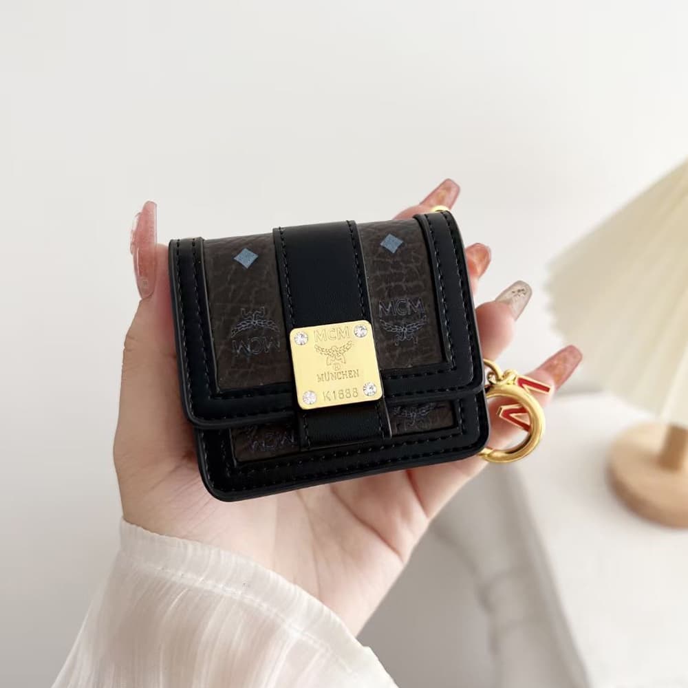 MCM Luxury AirPods & Samsung Buds Case - Monogram Leather with Detachable 'M' Chain MCM Luxury AirPods & Samsung Buds Case - Monogram Leather with Detachable 'M' Chain