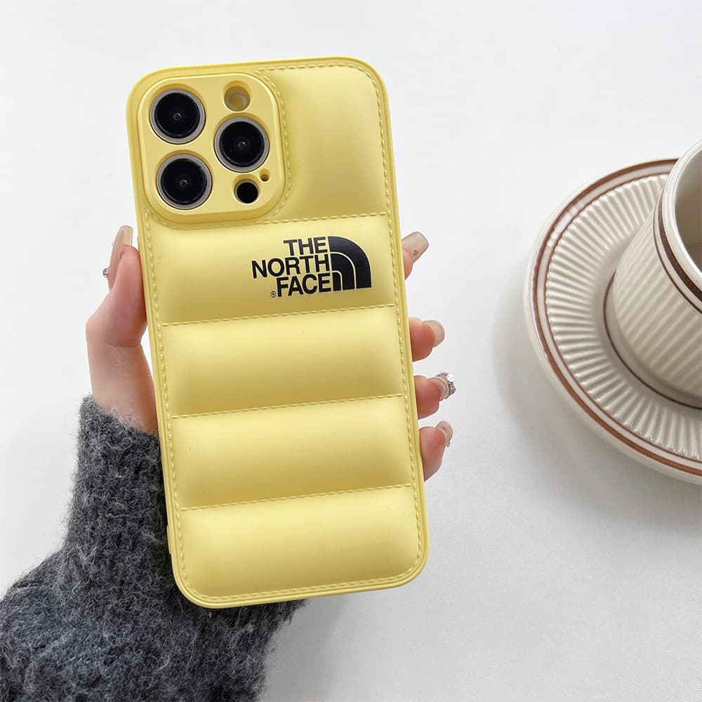 The North Face Puffer iPhone Case - Quilted Outdoor Design with TNF Logo (Multiple Colors) The North Face Puffer iPhone Case - Quilted Outdoor Design with TNF Logo (Multiple Colors)