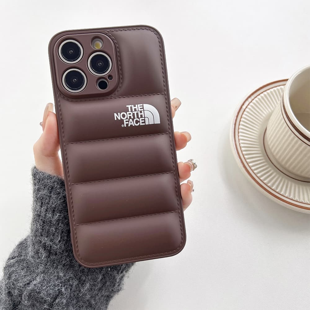 The North Face Puffer iPhone Case - Quilted Outdoor Design with TNF Logo (Multiple Colors) The North Face Puffer iPhone Case - Quilted Outdoor Design with TNF Logo (Multiple Colors)