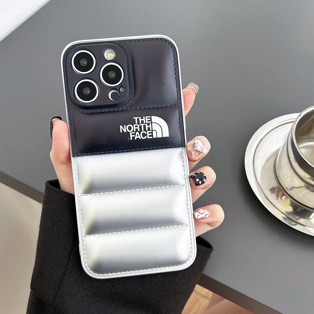 The North Face Puffer iPhone Case - Quilted Outdoor Design with TNF Logo (Multiple Colors) The North Face Puffer iPhone Case - Quilted Outdoor Design with TNF Logo (Multiple Colors)