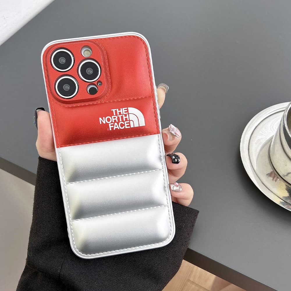 The North Face Puffer iPhone Case - Quilted Outdoor Design with TNF Logo (Multiple Colors) The North Face Puffer iPhone Case - Quilted Outdoor Design with TNF Logo (Multiple Colors)
