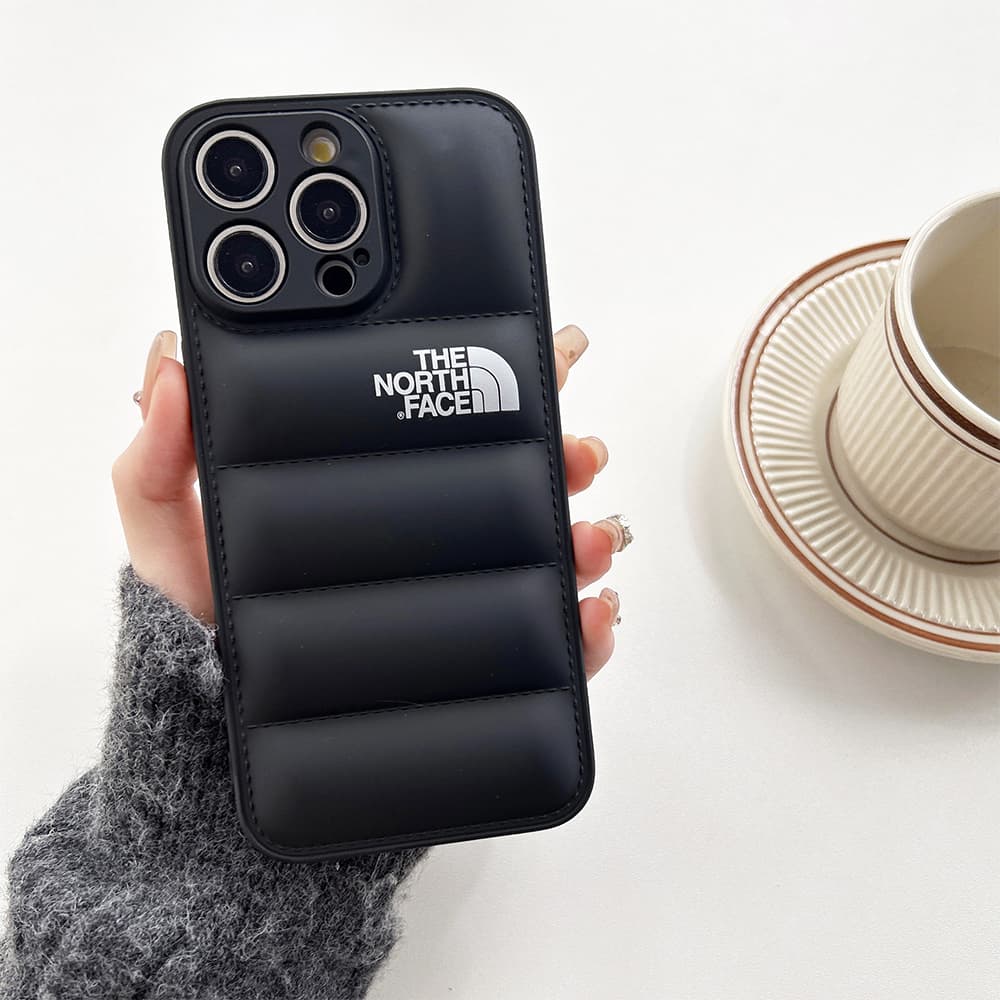 The North Face Puffer iPhone Case - Quilted Outdoor Design with TNF Logo (Multiple Colors) The North Face Puffer iPhone Case - Quilted Outdoor Design with TNF Logo (Multiple Colors)