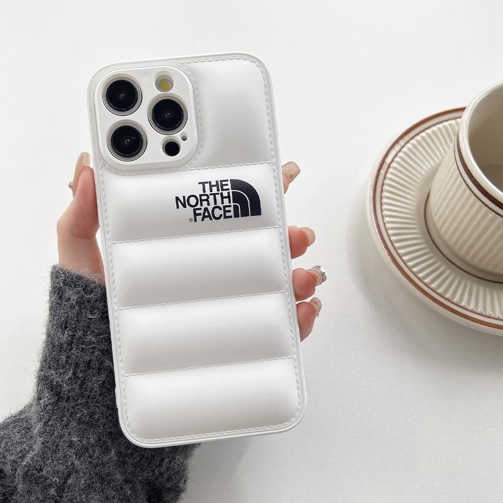 The North Face Puffer iPhone Case - Quilted Outdoor Design with TNF Logo (Multiple Colors) The North Face Puffer iPhone Case - Quilted Outdoor Design with TNF Logo (Multiple Colors)