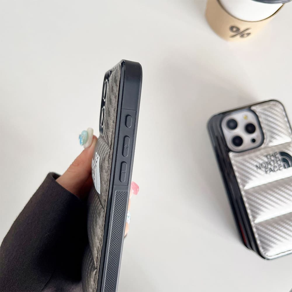 The North Face Luxury iPhone Case - Puffer Jacket Design with Carbon Fiber Texture (Rugged Protective Cover) The North Face Luxury iPhone Case - Puffer Jacket Design with Carbon Fiber Texture (Rugged Protective Cover)
