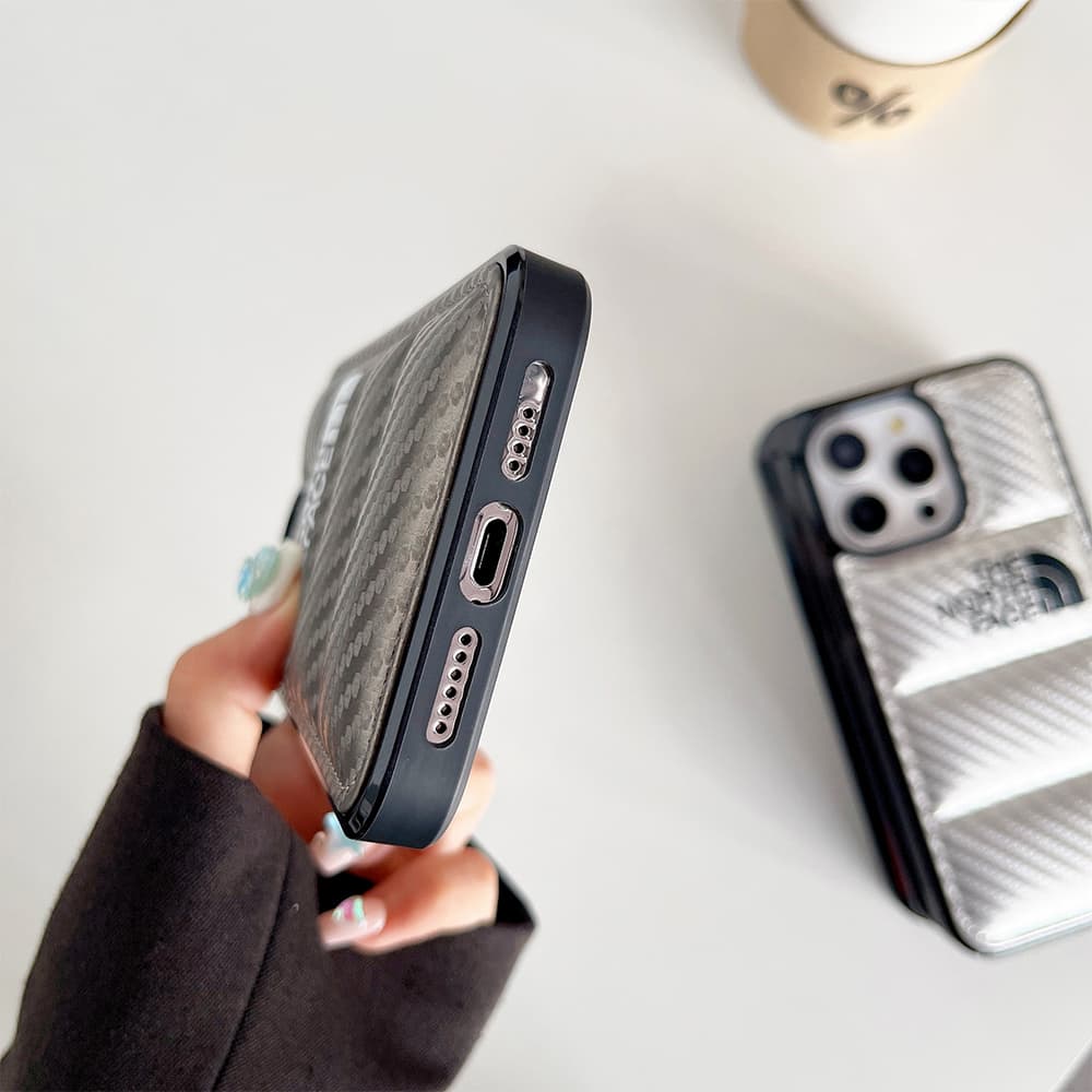The North Face Luxury iPhone Case - Puffer Jacket Design with Carbon Fiber Texture (Rugged Protective Cover) The North Face Luxury iPhone Case - Puffer Jacket Design with Carbon Fiber Texture (Rugged Protective Cover)