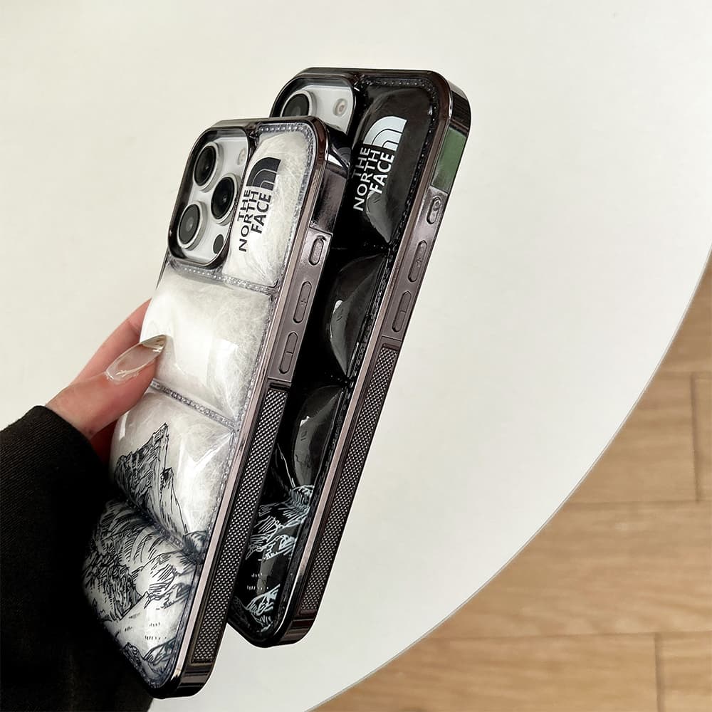 The North Face Luxury iPhone Case - Mountain Print with Puffer Quilted Design The North Face Luxury iPhone Case - Mountain Print with Puffer Quilted Design
